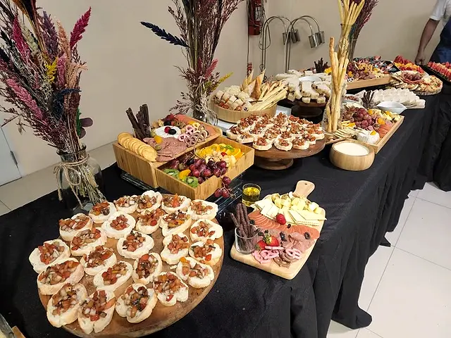 Catering spread with pastries, grazing boards and dried flower arrangements