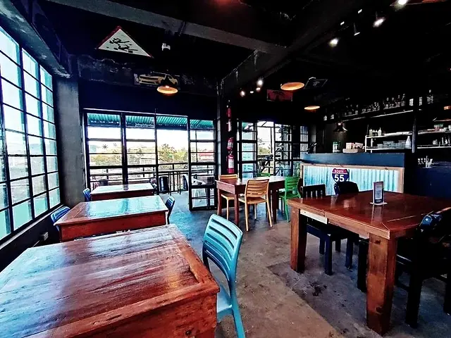 Route 55 dining area with wooden tables and big windows looking out over Baguio