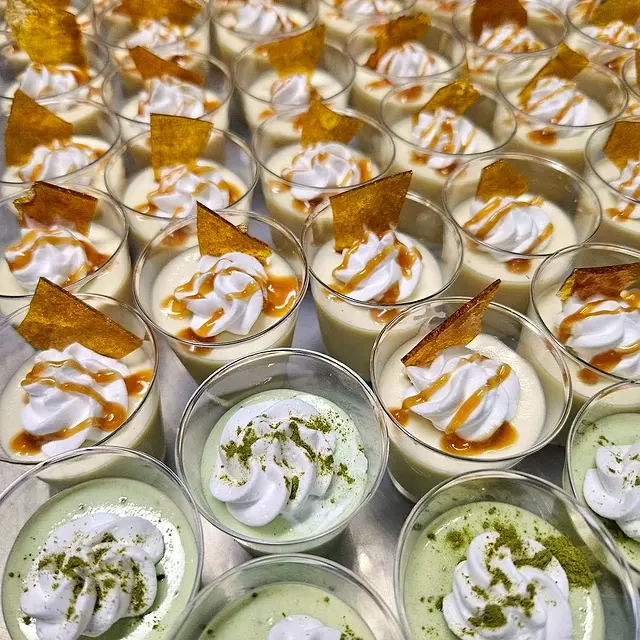 Dessert cups with whipped cream and caramel shards